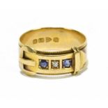 An Edwardian yellow gold buckle ring set with central diamond flanked by two sapphires, Chester