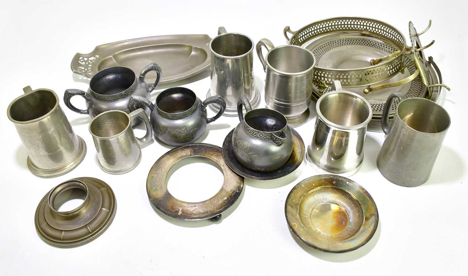 A quantity of pewter to include teapots, mugs, trays, etc.