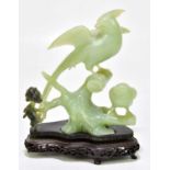 A Chinese green hardstone carving of birds perched on branches, on stand, height 22.5cm.