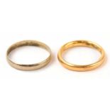 A yellow gold wedding band, size L, together with a further white metal example, size O.