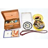 A large quantity of assorted costume jewellry, including a strand of cherry amber coloured beads,