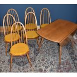 ERCOL; a light elm drop-leaf dining table, width 112cm, together with six spindle back dining chairs