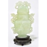 A Chinese carved green hardstone vase with cover, on stand, total height 24cm.