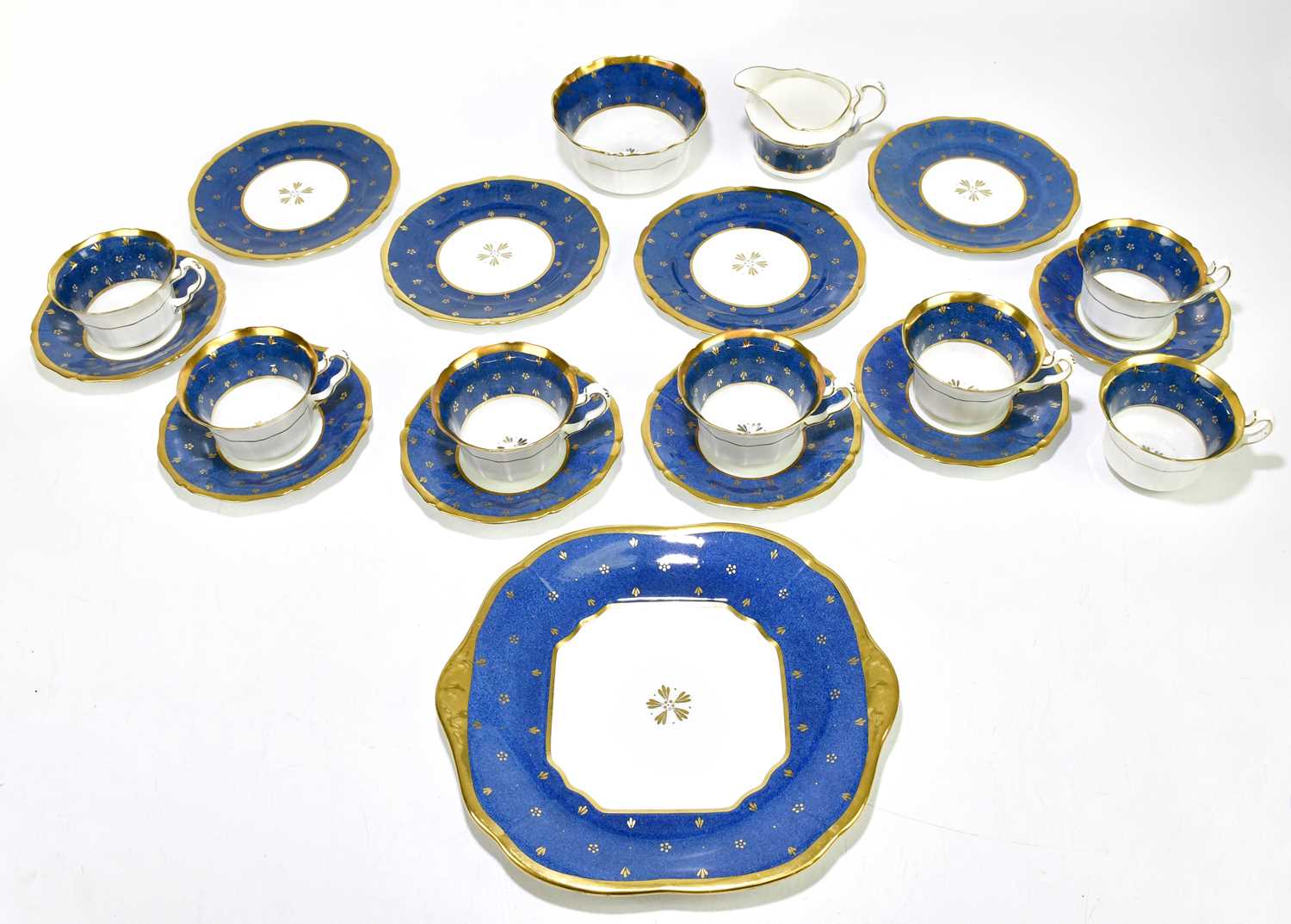 MAPLE LONDON; a part tea set, comprising six saucers, six cups, four side plates, a cream jug, a