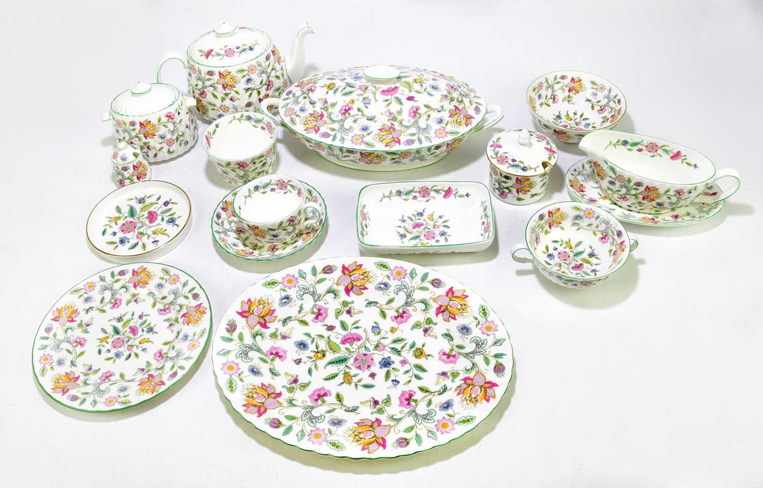 MINTON; a 'Haddon Hall' pattern dinner set, to include two sauce boats, four tureens, two candle