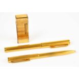 DUNHILL; a gold plated fountain pen with 14ct nib, and matching ballpoint pen, with engine turned
