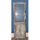 A vintage wooden train interior door with frosted glass panel and the Manchester coat of arms,