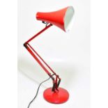 A modern red Anglepoise lamp.