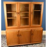 ERCOL; a light elm dresser, the back section with three glazed doors above three panelled cupboard