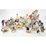 A large collection of 19th century Staffordshire figures, comprising flatbacks, spill vases,