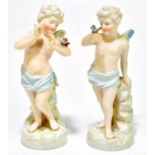 A pair of Continental porcelain figures of winged cherubs with butterflies, blue anchor marks to