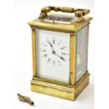 A late 19th century French brass repeating carriage clock with swing loop handle above white