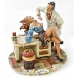 CAPODIMONTE; a figure group of doctor and patient, height 28cm.