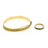 A 9ct yellow gold bangle with chased decoration of hearts, approx. 14.5g, with a 9ct yellow gold