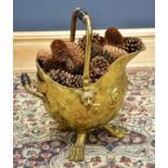 A 19th century brass coal scuttle with embossed pineapple detail and raised on three paw feet.