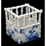 An early 20th century Japanese blue and white porcelain basket with bamboo upper body above hand