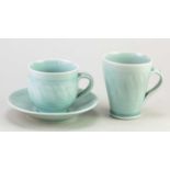 † DEREK EMMS (1929-2004); a porcelain cup and saucer covered celadon glaze, impressed DE mark,