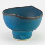 † ABDO NAGI (1941-2001); a stoneware pedestal bowl covered in mottled turquoise glaze with bronze