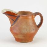 JEFF OESTREICH (born 1947); a wood fired stoneware jug with iron decoration to the spout,