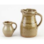 † RICHARD BATTERHAM (1936-2021); a stoneware jug covered in green ash glaze, height 18cm, and a