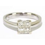 An 18ct white gold and diamond ring set with four princess cut stones totalling approx. 0.40cts,
