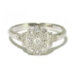 A platinum and diamond ring with illusion set platform, and further stones to the shoulders, size L,