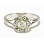 An 18ct white gold and nine stone diamond cluster ring, size N, approx. 2.9g, the ring head