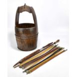 A quantity of swagger sticks, together with a Chinese treen bucket.