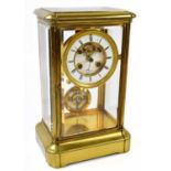 A French brass four glass mantel clock with white enamel dial, set with Roman numerals, height