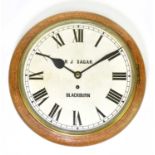 R.J SAGAR, BLACKBURN; an oak cased railway clock, the dial set with Roman numerals, with fusee