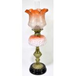 A Victorian oil lamp, the clear and cranberry glass shade with etched floral decoration above the