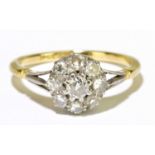 An 18ct yellow gold platinum tipped diamond floral set ring, the central raised stone approx. 0.