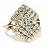 An Indian yellow metal and diamond set ring of stepped design, with forty-three round brilliant
