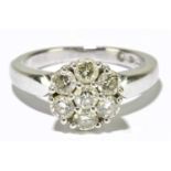 An 18ct yellow gold and diamond floral set ring with seven round brilliant cut stones totalling