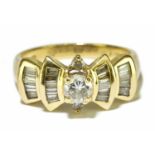 An 18ct yellow gold and diamond dress ring, the central round brilliant cut four claw set diamond