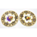 A SHUCK FOR ROYAL WORCESTER; a pair of cabinet plates decorated with fruit, diameter 22cm. Condition