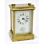 A brass repeating carriage clock with allover engraved detail and Roman numerals to the