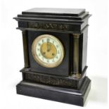 A Victorian slate mantel clock with applied metal panels and Corinthian columns, the dial bearing