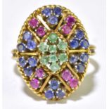 An 18ct yellow gold emerald, ruby, and sapphire set domed oval cluster ring with pierced basket