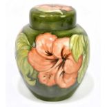 MOORCROFT; a ginger jar and cover in the 'Hibiscus' pattern on a cream ground, original paper