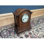 An early 20th century oak mantel clock, with white enamel dial set with Roman numerals, height