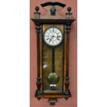 A 19th century rosewood veneered and beech Vienna style wall clock, the shaped pediment with applied