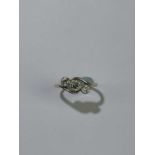 A yellow metal diamond set three stone ring, central stone approx .50ct, approximate size N,