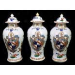 SAMSON; three Chinese style armorial lidded vases in the Famille Verte palette, height 27.5cm (3).