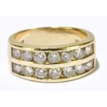 A 14ct yellow gold diamond set ring with fourteen round brilliant cut stones in twin channel