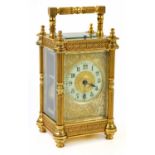 A 19th century French brass cased repeating carriage clock, with filigree decoration to the case and