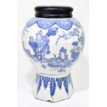 An 18th century Delft blue and white tin glazed earthenware vase of octagonal form, decorated in the