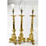 A set of three contemporary brass table lamps, heights including fitments 75cm. Condition Report: