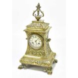 A late 19th/early 20th century French brass mantel clock with cast decoration of scrolling motifs
