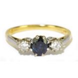 An 18ct yellow gold and platinum tipped sapphire and diamond three stone ring, the twin round